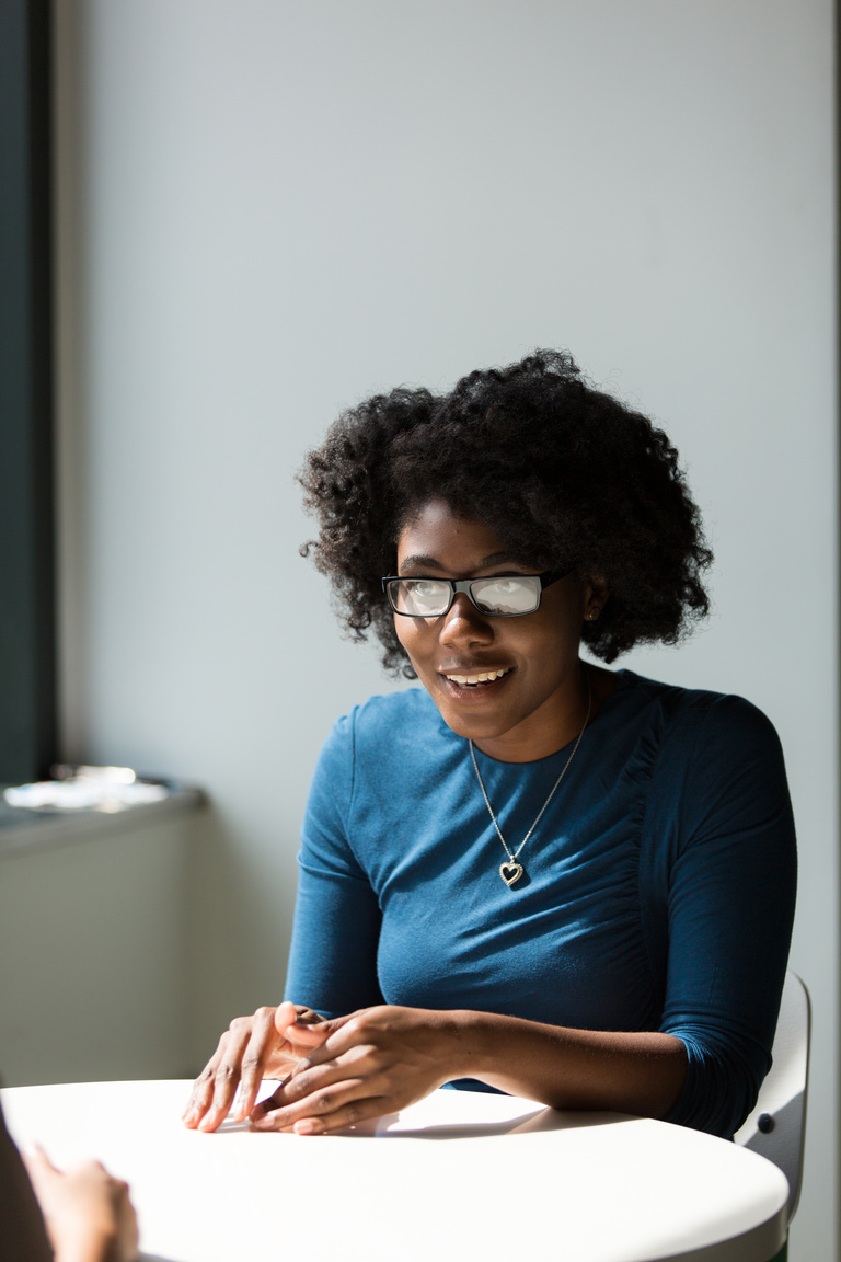 Woman Wearing Black Framed Eyeglasses and Blue Crew-neck Elbow-sleeved Top